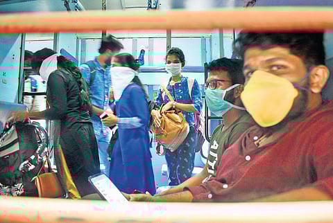 Youngsters travelling in a train wear face masks as part of precautionary measures due to the coronavirus scare. A scene from Kozhikode railway station on Monday | Manu R Mavelil