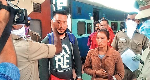 Health department and RPF personnel screening passengers with thermal scanners at the exit point of Palakkad Junction railway station on Monday | Express
