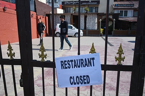 A closure notice is put up on the main gate of a restaurant in wake of the deadly coronavirus pandemic. (Photo | PTI)