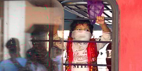 A boy whose face is covered with a towel seen inside a train, when it halted at Kozhikode Railway station. (Photo | TP Sooraj, EPS)
