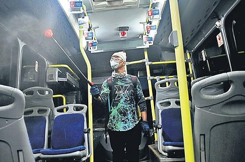 A worker sanitising Mo Bus in Bhubaneswar on Wednesday | Biswanath Swain