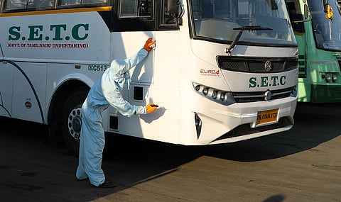 A worker sprays disinfectant on a SETC bus amid concerns over the spread of novel coronavirus at Koyembedu bus depot in Chennai. (Photo| V Tharunmani, EPS)