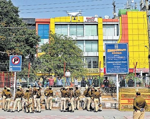 A drone surveils the area as security personnel stand guard near a barricade at Shaheen Bagh. (Photo | EPS)