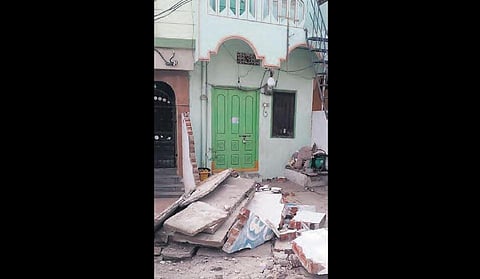 The debris of a wall that collapsed during the Pattana Pragathi works at Kotthur Janda in Hanamkonda on Sunday