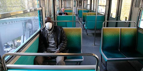 A man wearing a protective mask sits in a subway train in Paris on Thursday. (Photo| AP)