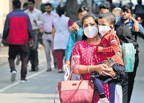 A mother and child wearing protective masks in the wake of COVID-19 outbreak, at Safdarjung Hospital on Wednesday | Shekhar Yadav