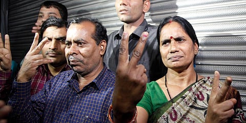 Nirbhaya's parents show victory sign after the hanging of their daughter's rapists in New Delhi on Friday. (Photo| Anil Shakya, EPS)