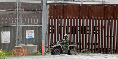 A border patrol agent rides a vehicle along a border wall separating Tijuana, Mexico, from San Diego. (Photo| AP)