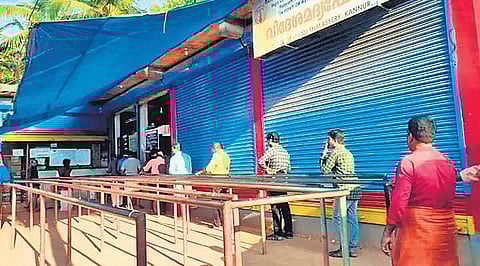 Tipplers standing in queue keeping the one-metre distance between them. A scene from Kandikkal Beverages Corporation outlet near Thalassery in Kannur