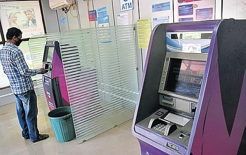 A man drawing money from ATM in Bhubaneswar on Friday. (Photo | EPS)