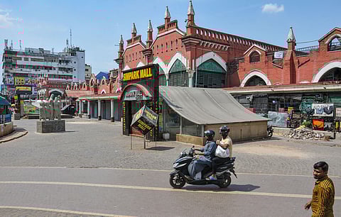 Commuters pass by a closed mall in the wake of deadly coronavirus in Kolkata Saturday March 21 2020. (Photo | PTI)