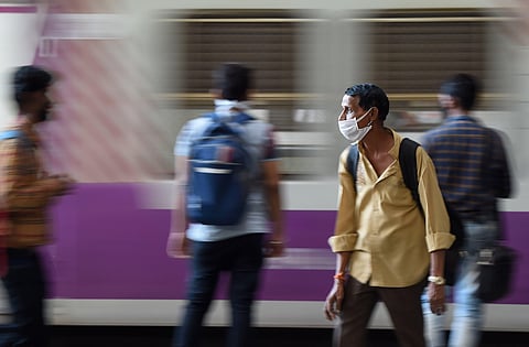 Passengers wearing face masks as a measure to prevent coronavirus spread are seen waiting at CST railway station in Mumbai Friday March 20 2020. (Photo | PTI)