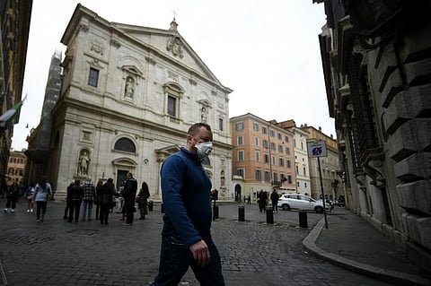 A man wearing a protective mask walks past the Church of St. Louis of the French (San Luigi dei Francesi) in Rome. (File Photo | AFP)