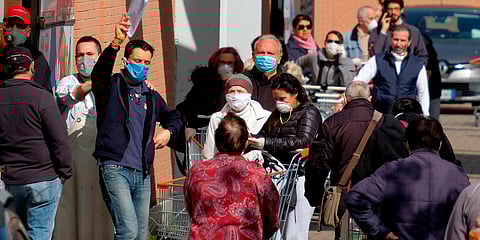 People line up to enter a supermarket in Rome on Saturday. (Photo| AP)