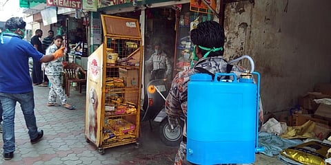 Municipal Corporation Chandigarh ( MCC) workers spray sanitizer on shops amid the rising cases of coronavirus, at the market in Sector 23. (File photo| ANI)