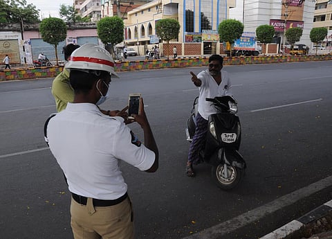 Police imposing fines as people flout rules prescribed by the district administration in Vijayawada on Tuesday. (Photo | Prasant Madugula,EPS)