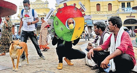 Mysuru-based artiste Yoganand creates awareness on COVID-19 through an art work on Monday | Udayshankar S