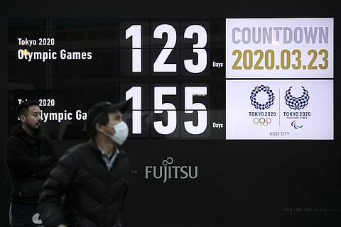 A man walks near a countdown display for the Tokyo 2020 Olympics and Paralympics in Tokyo, Monday, March 23, 2020. (Photo | AP)