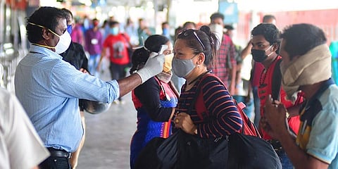 Bengaluru Railway staff thermal screening passengers at Krantivira Sangolli Rayanna railway station. (Photo | Shriram BN, EPS)