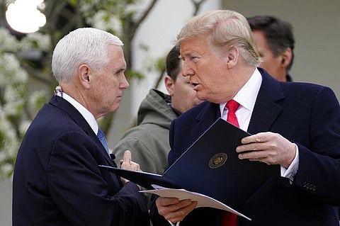 resident Donald Trump speaks with Vice President Mike Pence as they arrive for a Fox News Channel virtual town hall, at the White House, Tuesday, March 24, 2020, in Washington. (Photo | AP)
