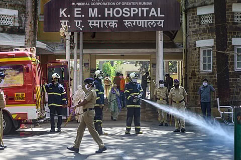 Municipal worker spray disinectants outside a hospital during lockdown amid the coronavirus pandemic in Mumbai Tuesday March 24 2020. (Photo | PTI)