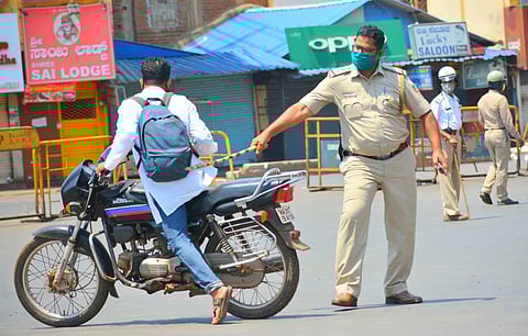 A police personnel punishes violator of section 144 during day-2 of a nationwide lockdown, imposed in the wake of coronavirus in Hubballi, Karnataka. (Photo | D Hemanth, EPS)