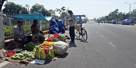 A Unit-1 vegetable market shifted to a main road of AG square to maintain social distancing during COVID-19 lockdown in Bhubaneswar on Thursday. (Photo| Biswananth Swain, EPS)