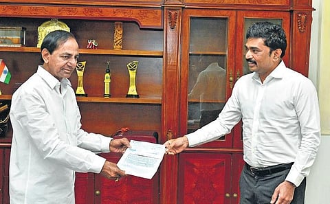 MEIL MD PV Krishna Reddy hands over a cheque of `5 crore to Telangana CM K Chandrasekhar Rao at Pragathi Bhavan in Hyderabad on Thursday