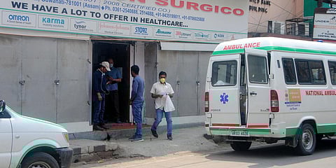 A man wearing a mask comes out from a Healthcare Center after getting essential medicines during the nationwide lockdown amid coronavirus outbreak, in Guwahati. (Photo| ANI)