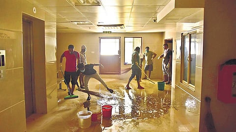 DYFI workers cleaning PVS Hospital in Kaloor, which is being converted into a Covid care centre | Albin Mathew