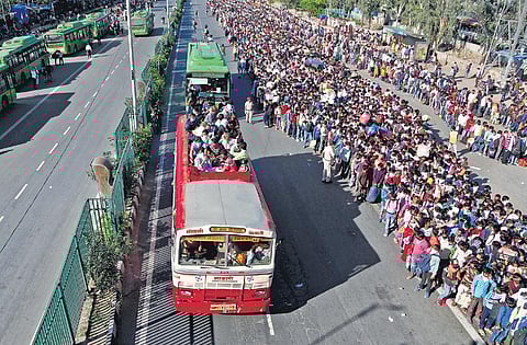 Migrants wait to board a bus to their native village at Anand Vihar in Delhi. (Photo | Anil Shakya, EPS)