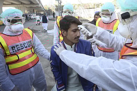 Pakistani health personnel take part in a drill as a preventative measures during an emergency of coronavirus outbreak in Peshawar. (Photo| AP)