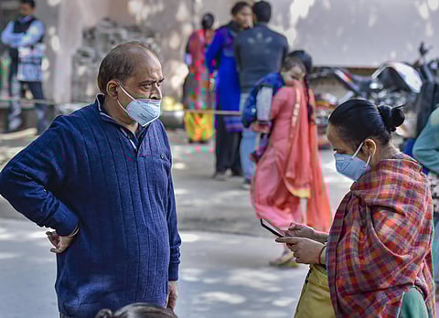 People wearing protective masks in the wake of novel coronavirus or COVID-19 outbreak stand outside RML Hospital in New Delhi Tuesday March 3 2020. (Photo | PTI)