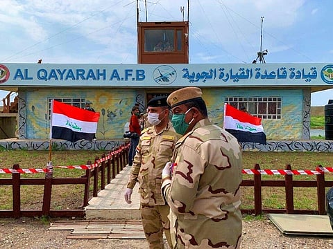 Iraqi soldiers stand guard during the hand over ceremony of Qayyarah Airfield, Iraqi Security Forces, in the south of Mosul, Iraq early Friday, March 27, 2020. (Photo | AP)