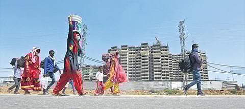 Migrant families make the long journey back home on foot at Sohna Road in Haryana on Sunday. States have been directed to ensure that there is no movement of people across cities or on highways | Shekhar Yadav