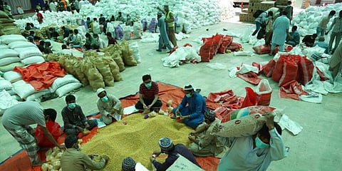 Volunteers prepare food packages for people stranded in their homes due to the lockdown to contain the outbreak of the coronavirus, in Karachi, Pakistan. (Photo | AP)