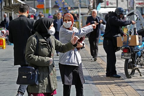 Iranians wear protective masks in Tehran on Wednesday (Photo | AFP)