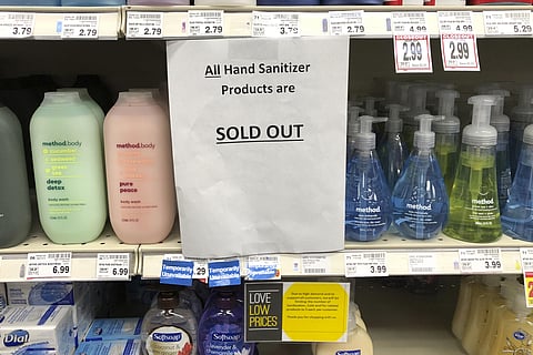 A sign on a shelf at a QFC grocery store in Kirkland, Wash., advises shoppers Tuesday, March 3, 2020 that all hand sanitizer products are sold out. (Photo | AP)