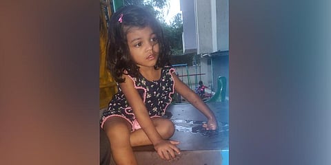 Ayaana Vishnu’s parents tried to help her while she was stuck on a slide in a park, in Bengaluru on Sunday