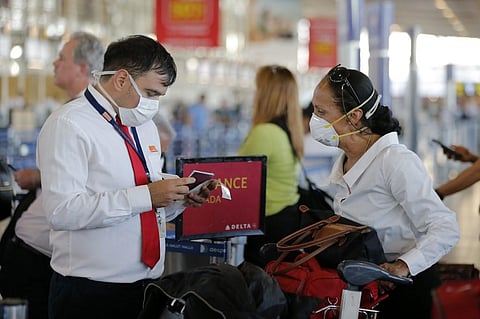 An airline staff member wears a protective mask as a preventive measure against the spread of coronavirus at the Arturo Merino Benitez International Airport, Santiago. (Photo | AFP)