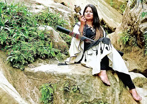 Anju Sharma with two of the musical instruments she uses in her healing practice.