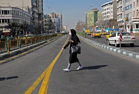 An Iranian woman wears a protective mask in Tehran on Wednesday (Photo | AFP)