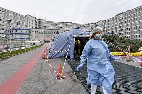 A paramedic walks out of a tent that was set up in front of the emergency ward of the Cremona hospital, northern Italy. (Photo | AP)