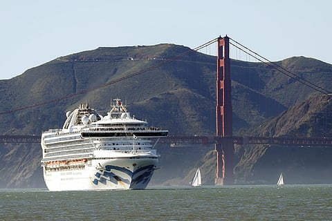 In this Feb. 11, 2020 photo, the Grand Princess cruise ship passes the Golden Gate Bridge as it arrives from Hawaii in San Francisco. California's first coronavirus fatality is an elderly patient who apparently contracted the illness on a cruise, authorit