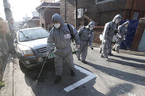 South Korean army soldiers spray disinfectant as a precaution against the coronavirus on a street in Seoul, South Korea, Thursday, March 5, 2020. (Photo | AP)