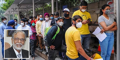 People wear masks as they stand in a queue for COVID-19 screening at Ram Manohar Lohia Hospital in New Delhi (Left: Dr T Jacob John )
