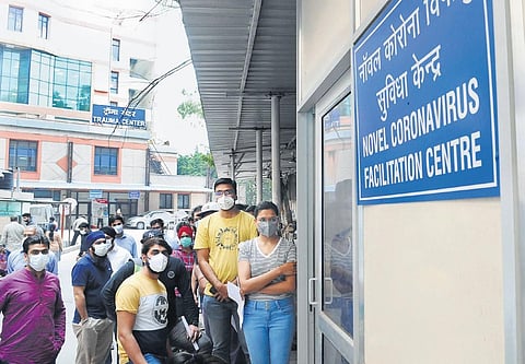 People queue up outside a screening centre for Corona suspects at Delhi’s Ram Manohar Lohia Hospital.