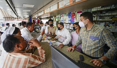 Salesmen at a chemist shop wear protective masks in wake of coronavirus outside Safdarjung Hospital in New Delhi. (Photo| PTI)