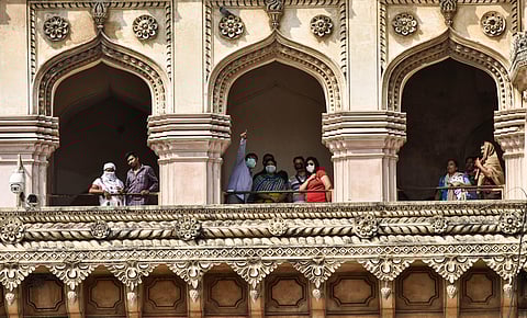 Tourists wear masks as they visit Charminar in Hyderabad on Wednesday (Photo | Vinay Madapu, EPS)