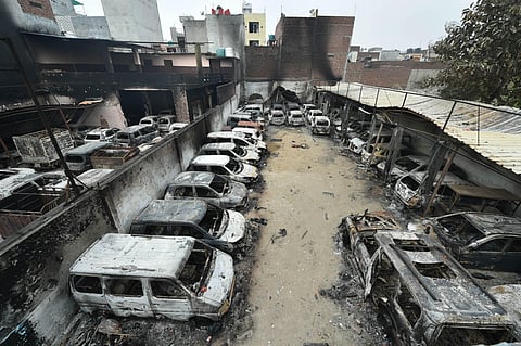 Charred remains of vehicles set ablaze by rioters during communal violence over the amended citizenship law at Shivpuri area of north east Delhi Thursday Feb. 27 2020. (Photo| PTI)